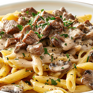 Penne pasta topped with creamy beef stroganoff sauce